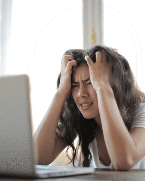Image of stressed out woman holding her head